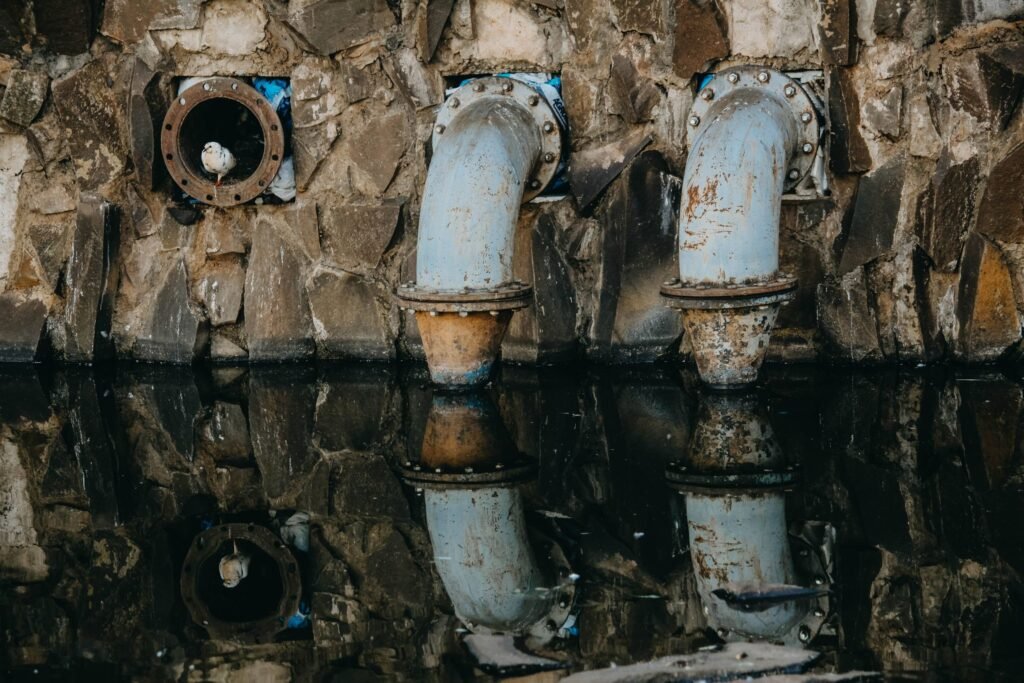 Cast iron pipes standing in dark water