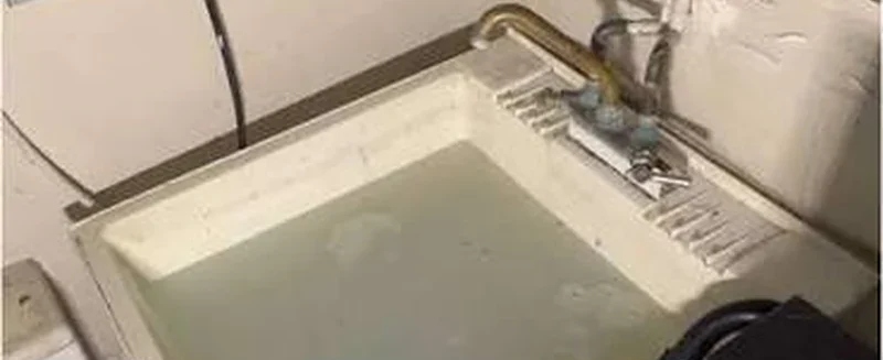 Basement floor drain filled with standing water